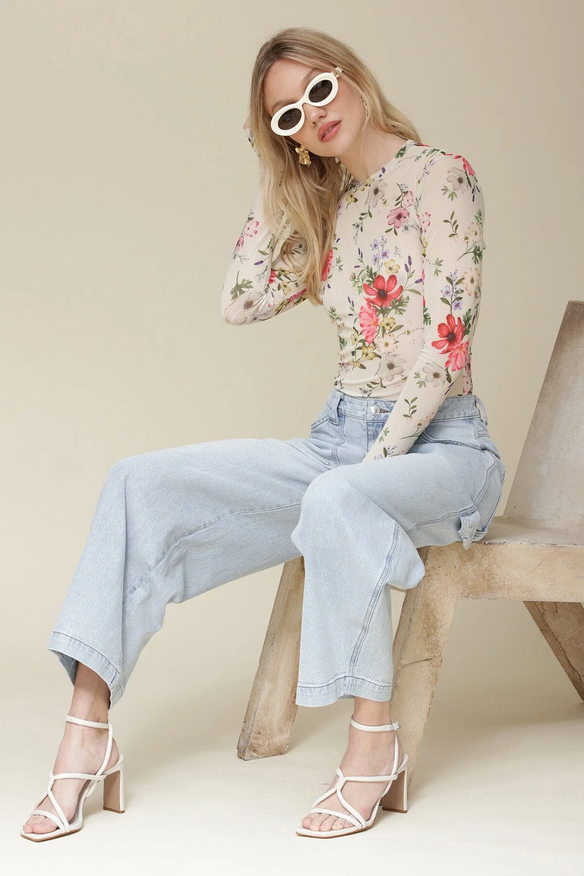 Luna and Bloom Press page image of female model in light wash blue barrel high waist jeans with front cargo pockets sat down