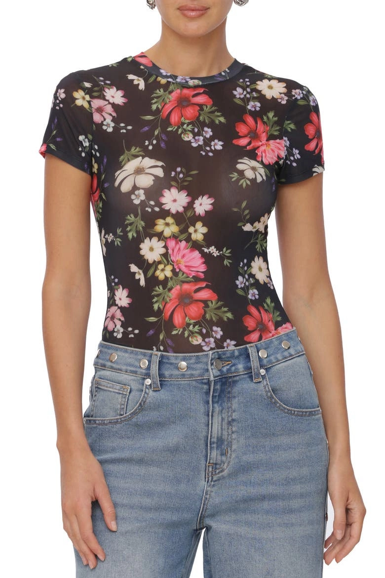 Luna and Bloom Press page image of female model no face shown in blue jeans with close fit black top and multi colour floral